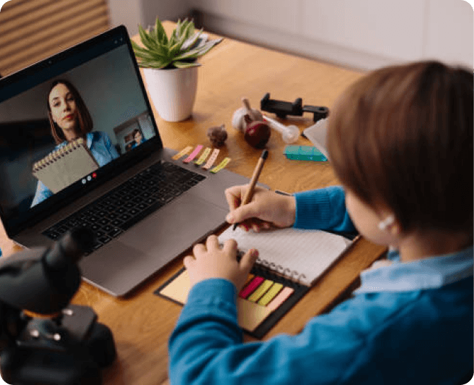 A person sitting at a table with a laptop